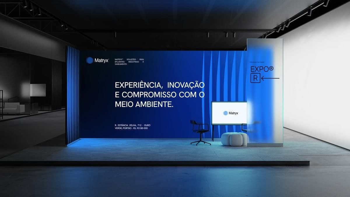 Branded exhibition stand with a large backdrop, screen, and seating area